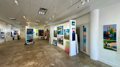 Inside Butter Gallery in Collingwood: paintings on white walls and freestanding panels on a stone floor
